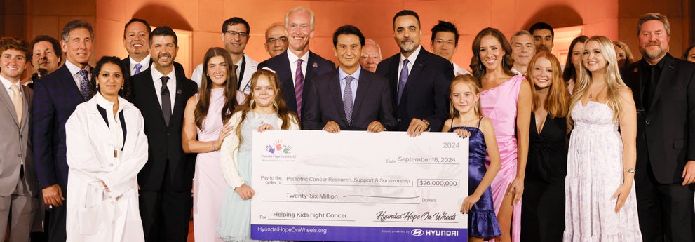 helping kids fight cancer foundation showing their big check from hyundai hope on wheels - Glassman Hyundai in Southfield MI